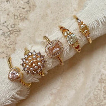 Load image into Gallery viewer, 24kae ring with stones and heart shaped detail
